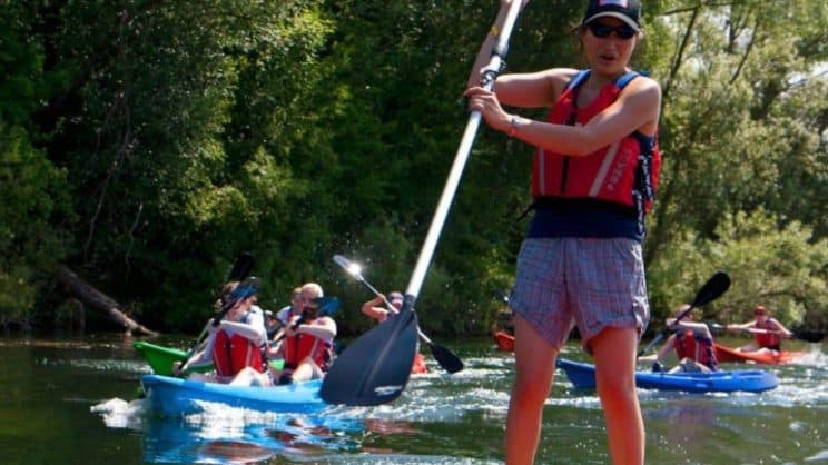 Paddlesport Leader. A group on the water in sit-on-tops and paddleboards.